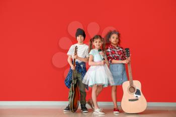 Band of little musicians against color wall�