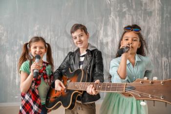 Band of little musicians against grunge wall�