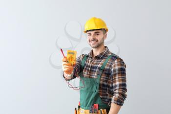 Male electrician on light background�