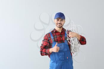 Male electrician on light background�
