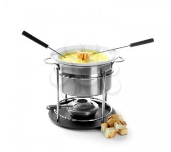 Fondue pot with melted cheese and bread on white background�