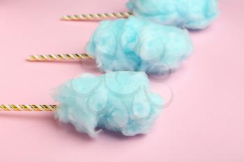 Tasty cotton candy on color background�