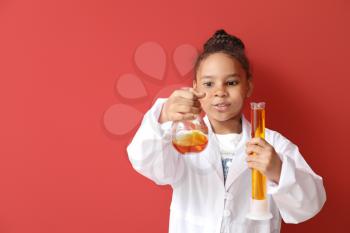Little African-American scientist on color background�