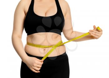 Overweight woman with measuring tape on white background. Weight loss concept�