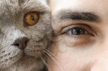 Young man with cute funny cat, closeup�