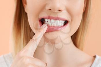 Beautiful woman with healthy teeth on color background, closeup�