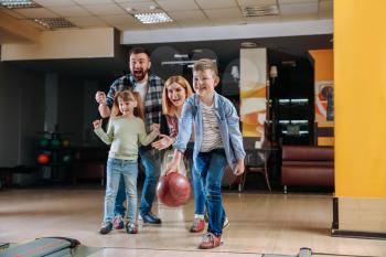 Family playing bowling in club�