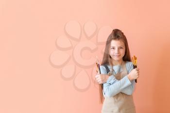 Cute little artist on color background�
