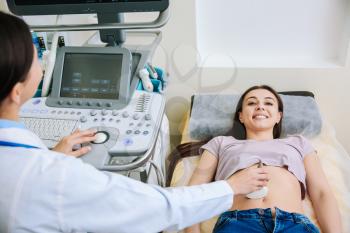 Woman undergoing ultrasound scan in clinic�