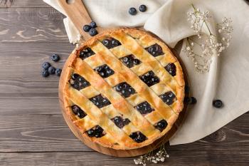 Tasty blueberry pie on wooden table�