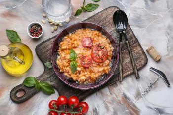 Plate with tasty risotto on grey background�