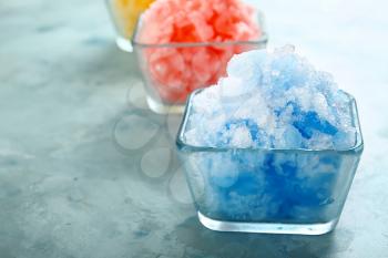 Bowl with tasty shaved ice on color background�