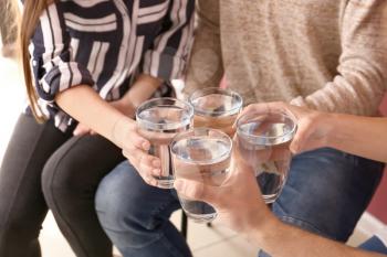 Group of people drinking water indoors�
