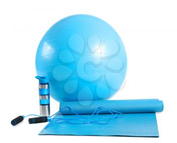 Set of sports equipment with fitness ball and bottle of water on white background�