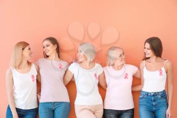 Beautiful women of different ages with pink ribbons on color background. Breast cancer concept�