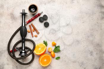 Parts of hookah and fruits on light background�