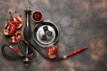 Parts of hookah and pomegranate on grunge background�