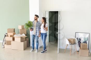 Young couple with belongings in their new house�