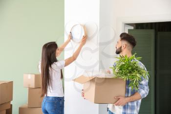 Young couple with belongings in their new house�