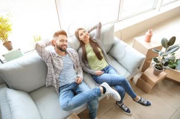 Young couple sitting in their new house�