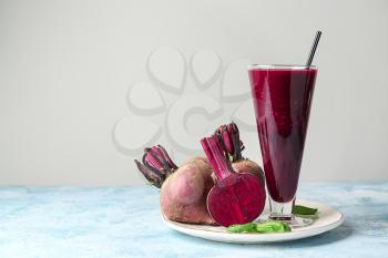 Glass of fresh beet smoothie on table�