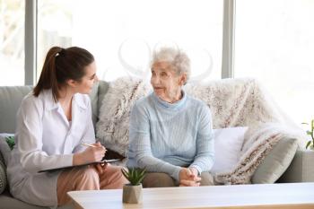 Doctor with senior woman in nursing home�