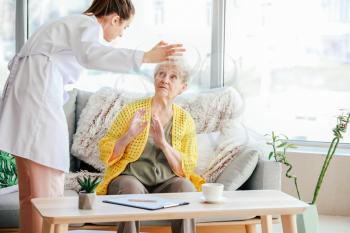 Doctor mistreating senior woman in nursing home�