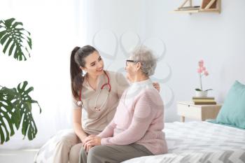 Doctor with senior woman in nursing home�