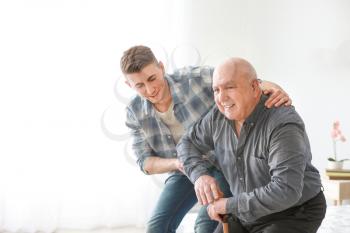 Caregiver with senior man in nursing home�