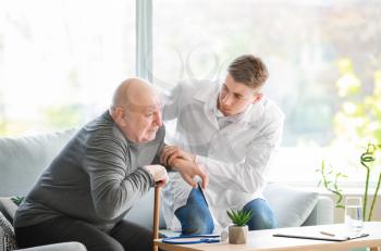 Doctor with senior man in nursing home�