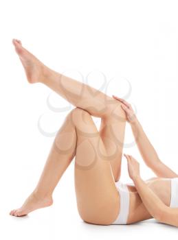 Beautiful young woman after laser hair removal of legs on white background�