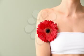 Beautiful young woman with flower on color background. Depilation concept�