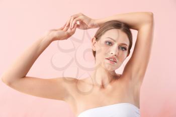 Beautiful young woman after laser hair removal procedure on color background�