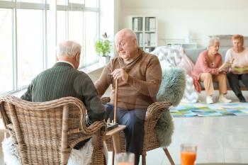 Senior men playing chess in nursing home�