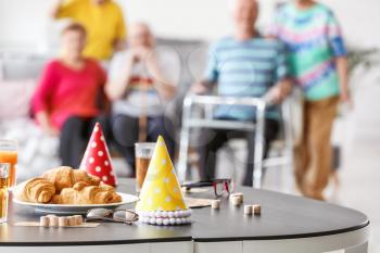 Table with party decor and bingo game on table in nursing home�