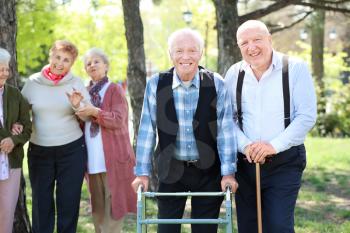 Group of senior people walking in park�