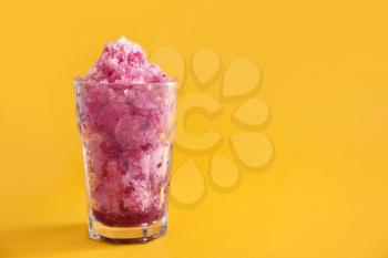 Glass with tasty shaved ice on color background�