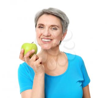 Mature woman with apple on white background�