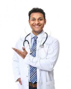 Handsome male doctor showing something on white background�