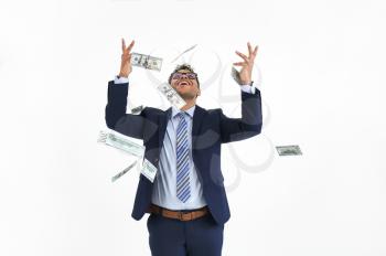 Happy businessman and falling dollar banknotes on white background�
