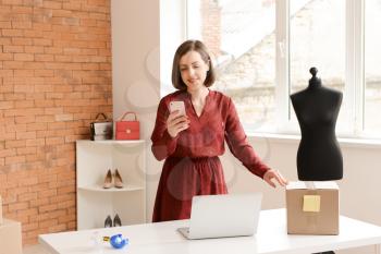 Female owner of online shopping site preparing order for client�
