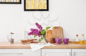 Beautiful lilac flowers on counter in kitchen�