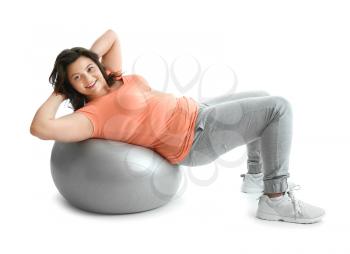 Plus size woman with fitball on white background. Concept of weight loss�