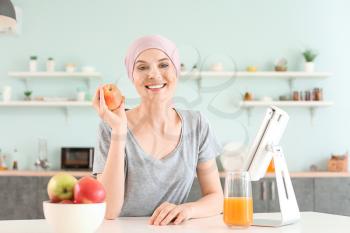 Woman after chemotherapy in kitchen at home�