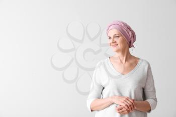 Mature woman after chemotherapy on light background�