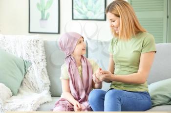 Little girl after chemotherapy with her mother at home�