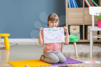 Cute little girl drawing at home�