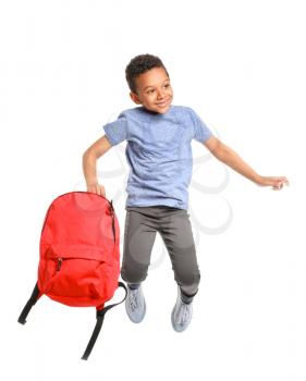 Jumping African-American schoolboy on white background�