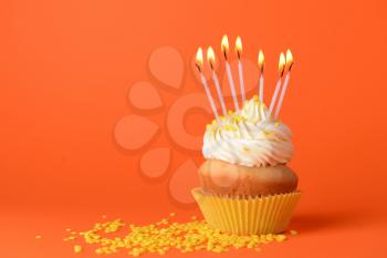 Tasty Birthday cupcake on color background�