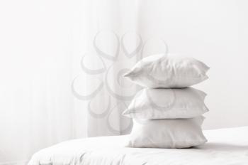 Soft pillows on cozy bed�